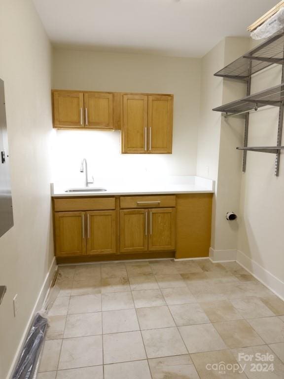 kitchen with sink and light tile patterned flooring