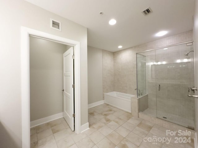 bathroom with tile patterned flooring and independent shower and bath