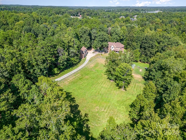 bird's eye view featuring a wooded view