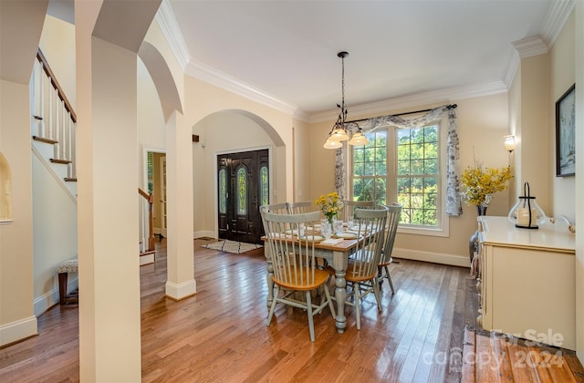 dining area with ornamental molding and wood-type flooring