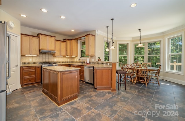 kitchen with stainless steel dishwasher, a center island, decorative backsplash, and dark tile patterned flooring