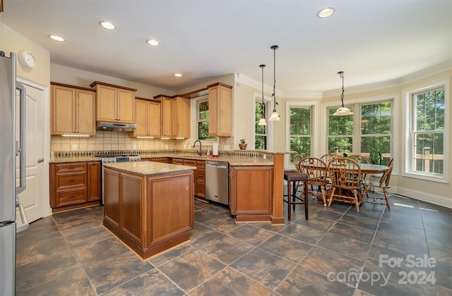 kitchen with tasteful backsplash, stainless steel dishwasher, a peninsula, light stone countertops, and under cabinet range hood