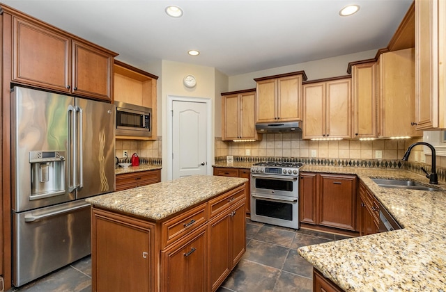 kitchen featuring backsplash, sink, a center island, dark tile patterned floors, and high quality appliances