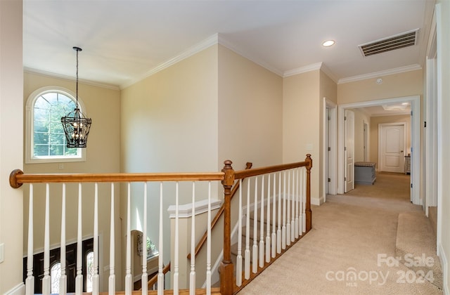 hallway featuring light carpet, a notable chandelier, and ornamental molding