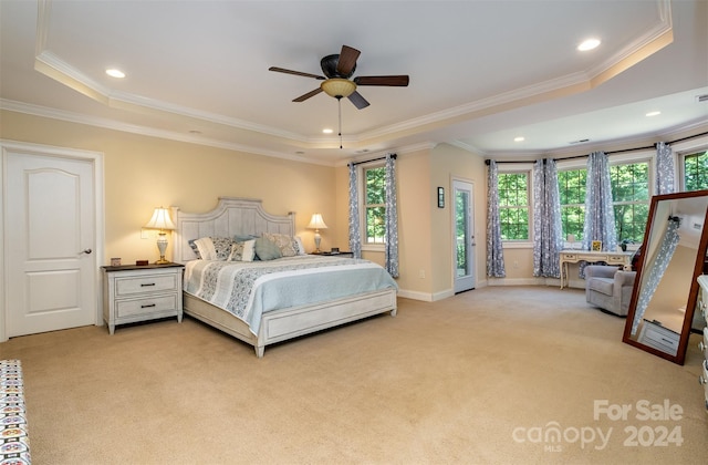 bedroom with ceiling fan, a raised ceiling, ornamental molding, and light carpet