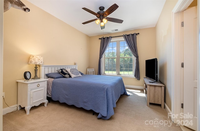 bedroom with a ceiling fan, light colored carpet, visible vents, and baseboards