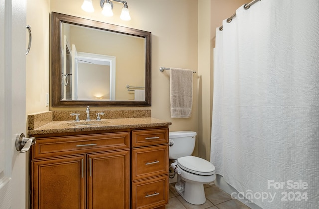 bathroom with tile patterned floors, vanity, and toilet