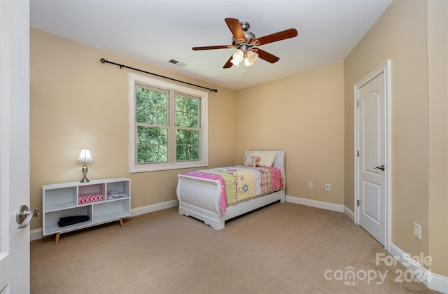 bedroom with ceiling fan and light colored carpet