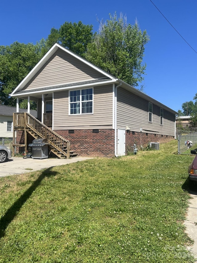 exterior space featuring central AC, a front yard, and a porch