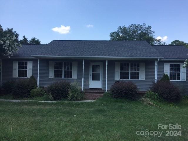 1245 Carolyn Ave, Kannapolis, NC 28083 - ranch-style house with a porch, a front lawn, and roof with shingles