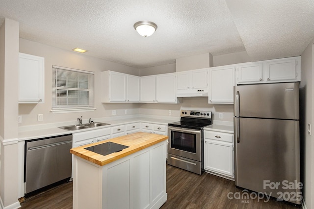 kitchen with white cabinetry, a kitchen island, and appliances with stainless steel finishes