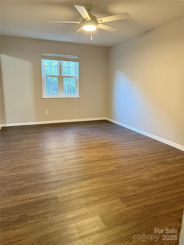 unfurnished room with dark wood-type flooring and ceiling fan