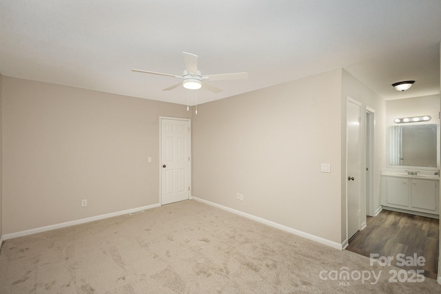 unfurnished room with ceiling fan and dark carpet