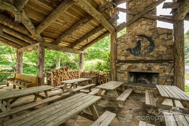 view of patio with an outdoor stone fireplace