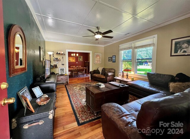 living room featuring crown molding, ceiling fan, and light hardwood / wood-style floors