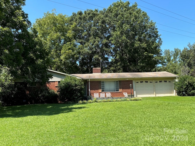 ranch-style home with a front lawn and a garage