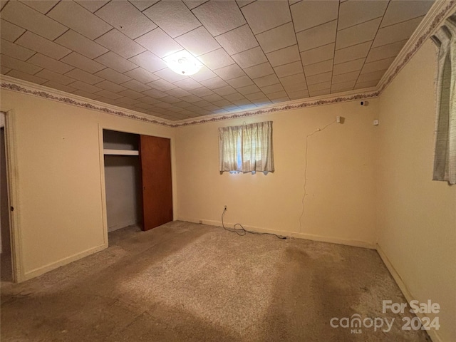 unfurnished bedroom with a closet and carpet