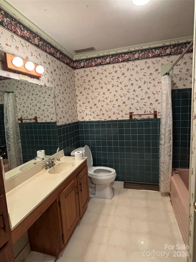 full bathroom featuring toilet, tile patterned flooring, vanity, tile walls, and shower / bathtub combination with curtain