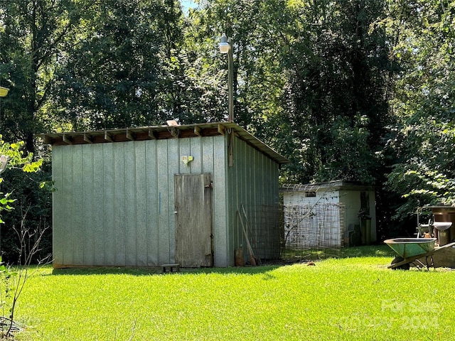 view of outbuilding featuring a lawn