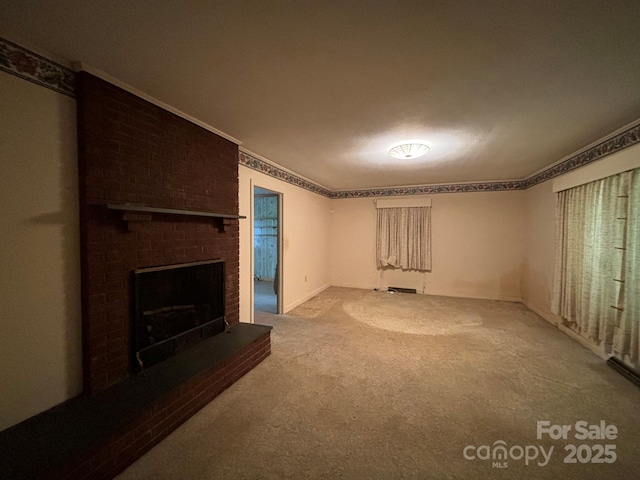 unfurnished living room featuring carpet floors, a brick fireplace, and crown molding