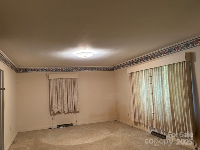 unfurnished room featuring carpet flooring and baseboards