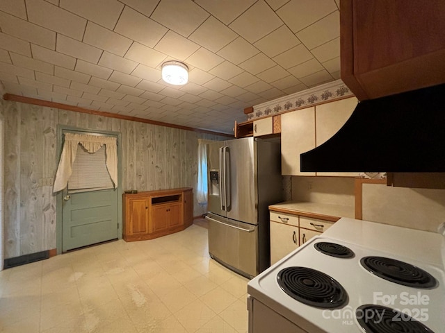 kitchen featuring electric stove, crown molding, custom exhaust hood, light countertops, and stainless steel fridge