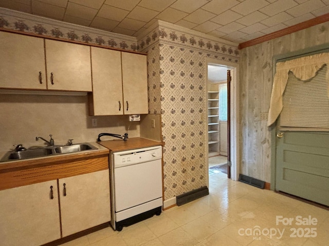 kitchen with crown molding, dishwasher, and a sink