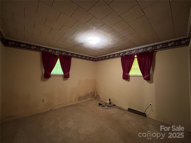 spare room with plenty of natural light and carpet flooring