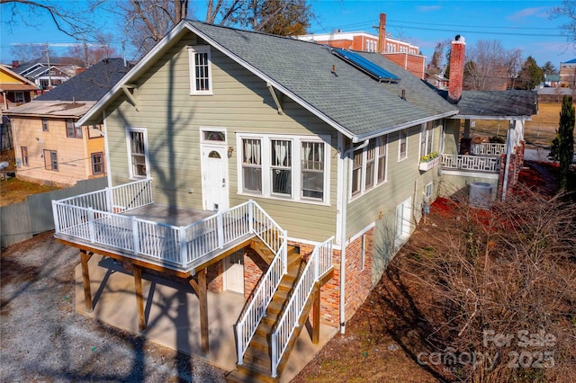 back of property featuring a deck