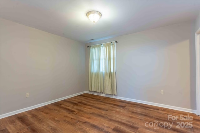 unfurnished room featuring hardwood / wood-style flooring