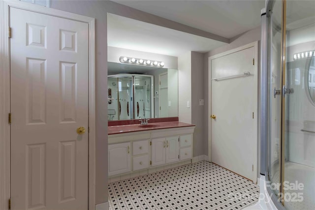 bathroom with walk in shower and vanity