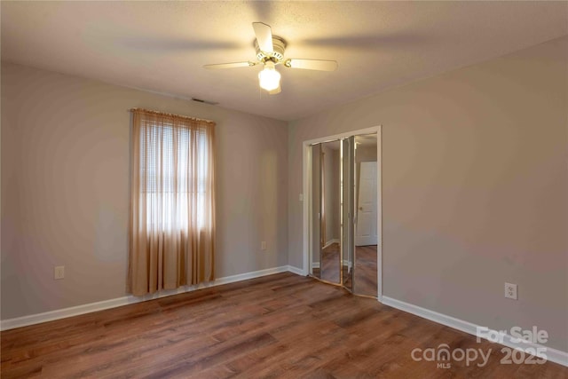 spare room featuring ceiling fan and wood-type flooring