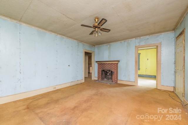 unfurnished living room with ceiling fan, carpet floors, and a fireplace