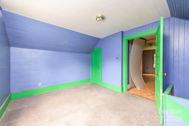 additional living space with vaulted ceiling and light colored carpet