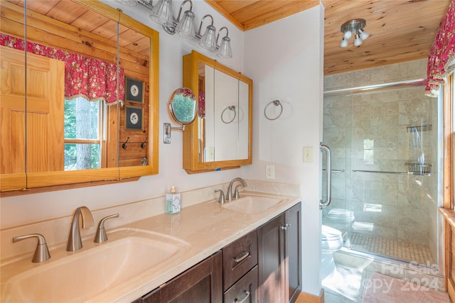 bathroom with vanity, toilet, a shower with shower door, and wood ceiling