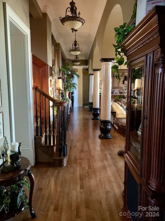 hallway with ornamental molding and hardwood / wood-style flooring