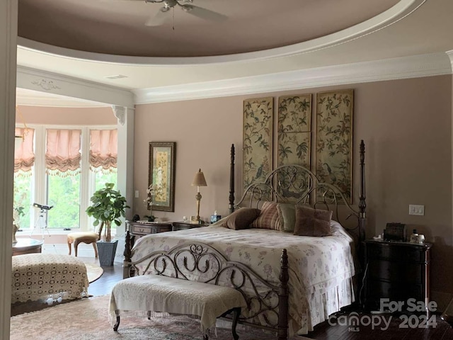 bedroom featuring ceiling fan, crown molding, and wood-type flooring