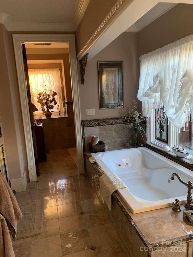 bathroom featuring a relaxing tiled tub, ornamental molding, and tile patterned floors