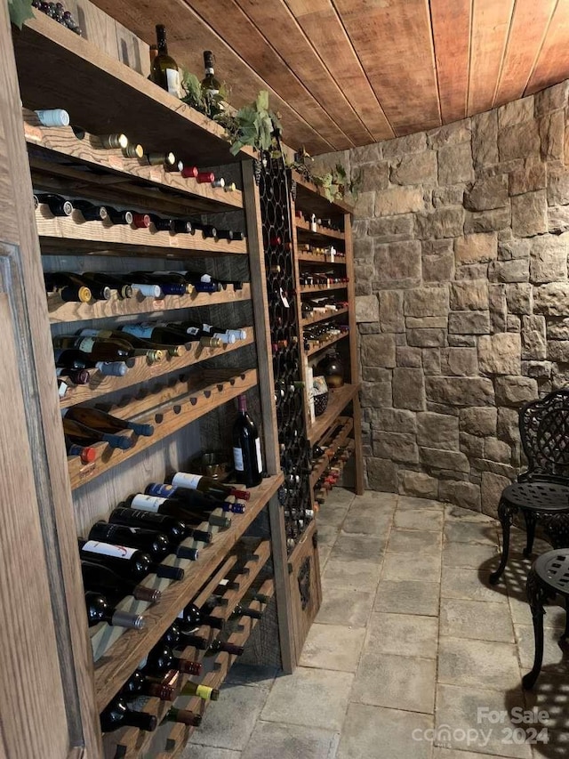 wine area with light tile patterned floors and wood ceiling