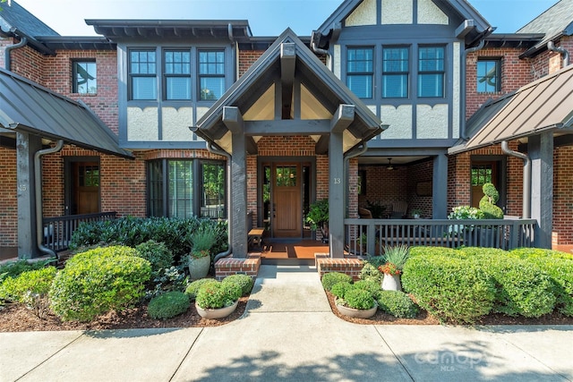 entrance to property with brick siding and covered porch