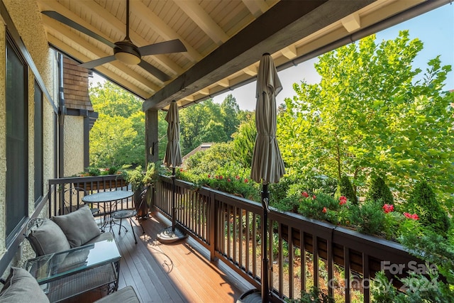 wooden deck featuring a ceiling fan