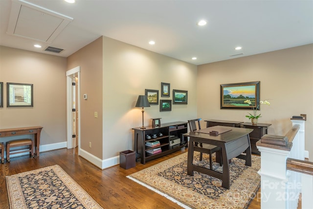 office space featuring visible vents, wood finished floors, recessed lighting, baseboards, and attic access