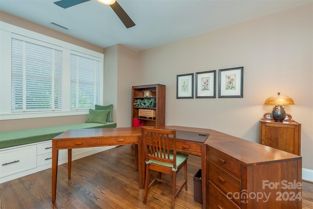 office featuring wood finished floors, visible vents, and ceiling fan