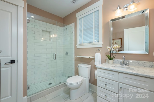 full bathroom with vanity, visible vents, baseboards, a stall shower, and toilet