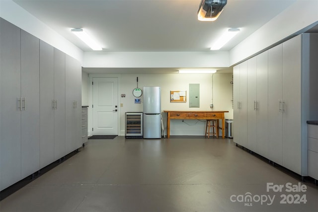 garage featuring electric panel, wine cooler, and a garage door opener