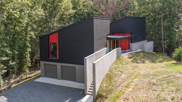 view of side of property with a garage and a yard