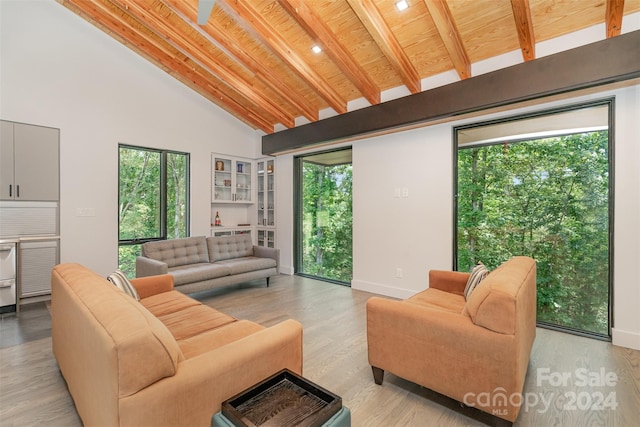 living room featuring plenty of natural light, beamed ceiling, high vaulted ceiling, and light hardwood / wood-style floors