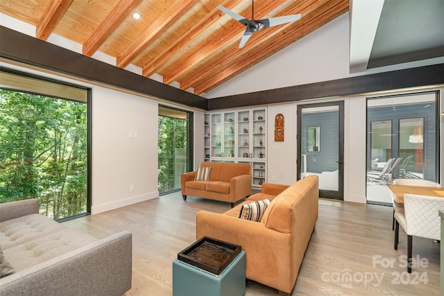 living room with light hardwood / wood-style flooring, ceiling fan, wooden ceiling, and a healthy amount of sunlight