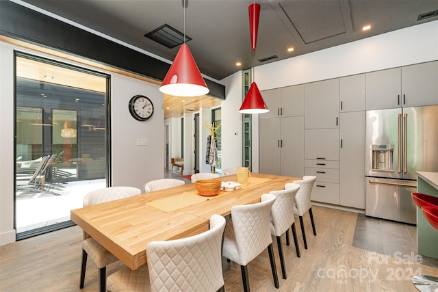 dining space with light hardwood / wood-style flooring