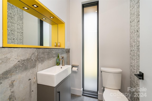 bathroom with backsplash, toilet, and vanity